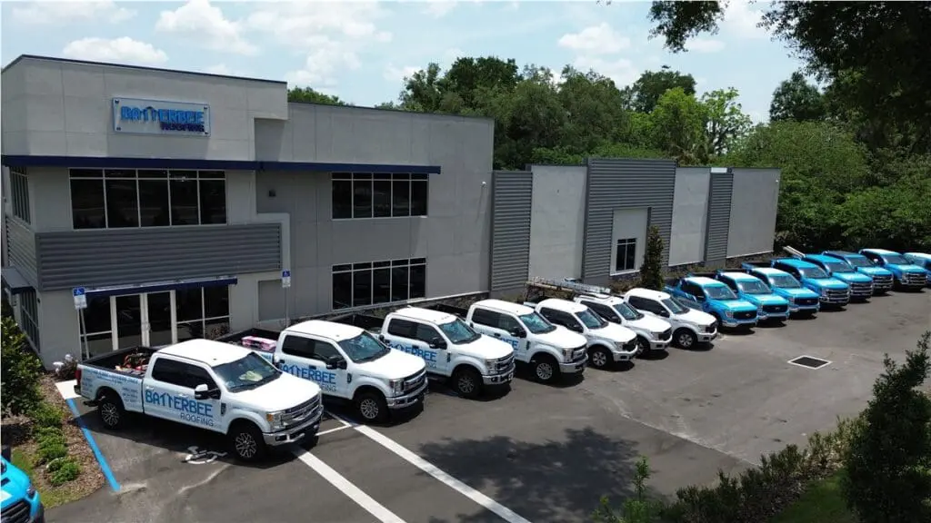 Batterbee Roofing headquarters with a fleet of branded service trucks