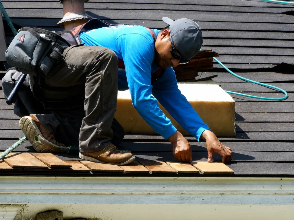 Roofing contractor installing asphalt shingles during residential roof replacement for Elite Roofing & Remodel, a Canopy Services partner brand